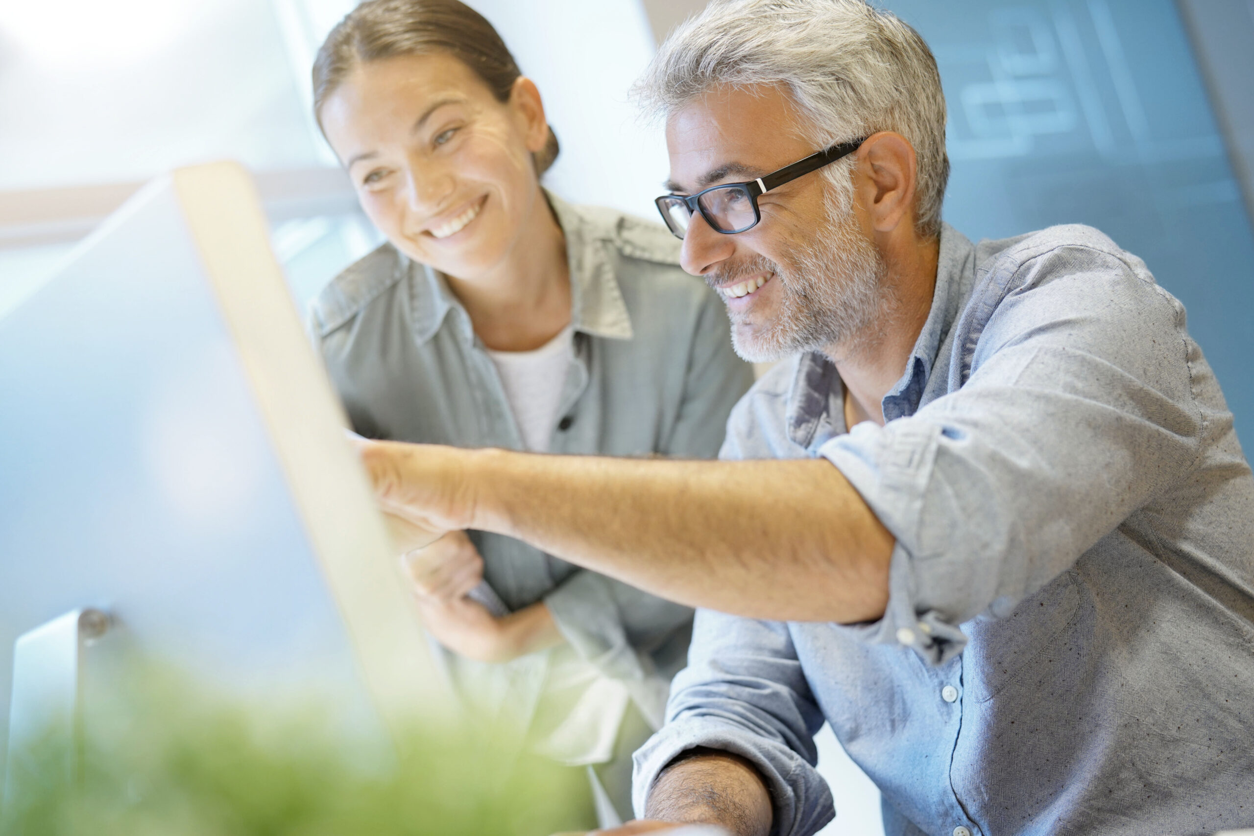 Cheerful informal coworkers working together in contemporary off